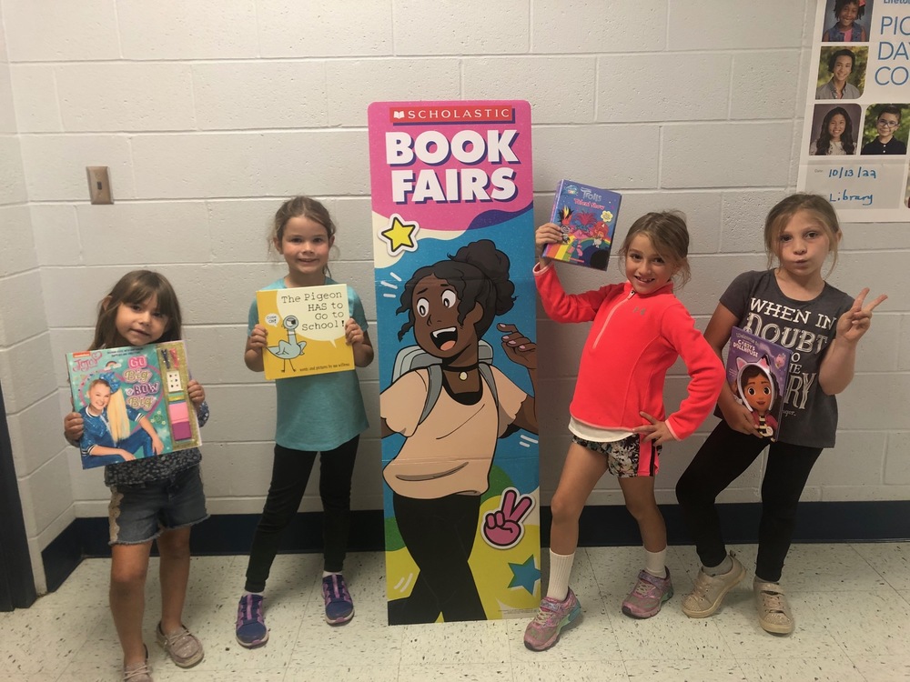 First Grade Students Brandish their New Books
